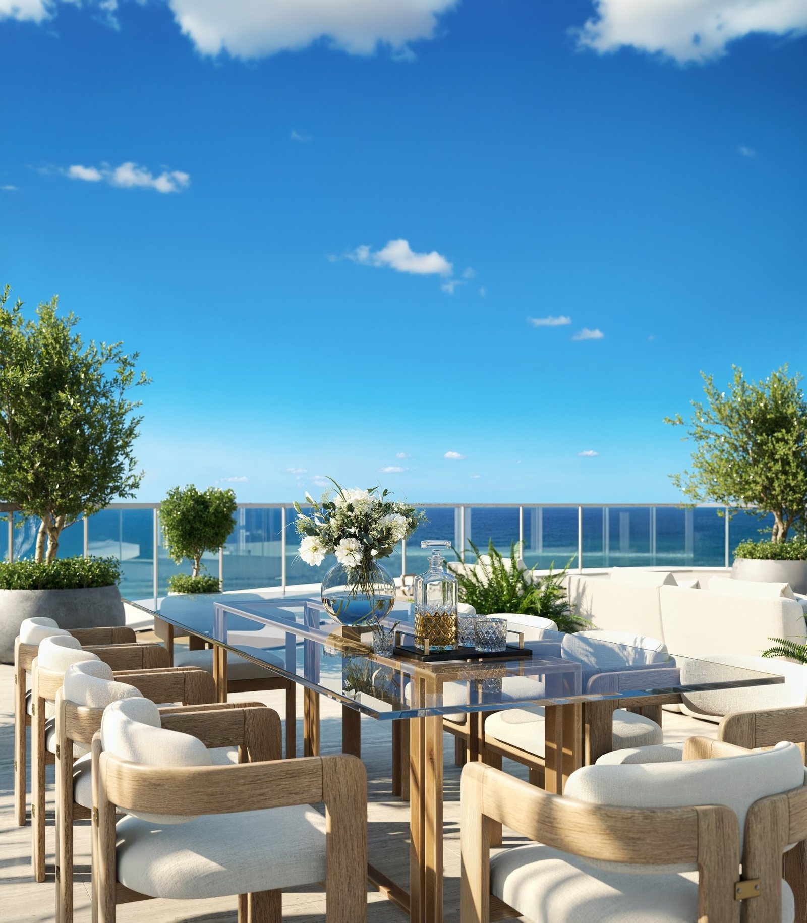 Rendering of the outdoor dining terrace of the Upper Penthouse with the ocean beyond the glass rail